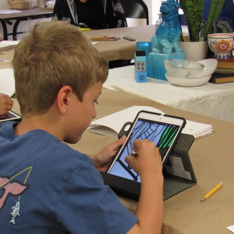 An artist academy attendee draws a still life in the Cultural Center’s iPad Media Arts Workshop.